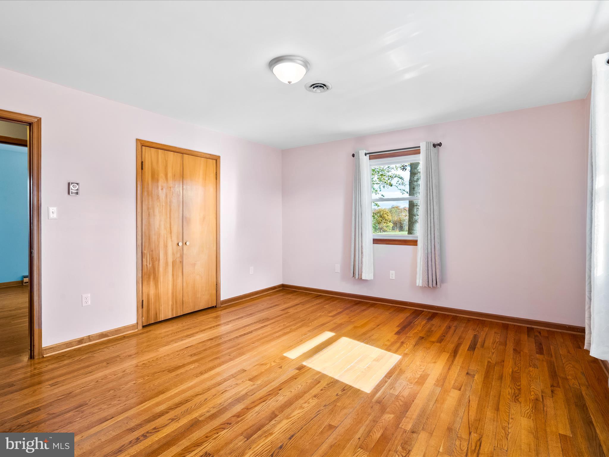 7429 Lewistown Road Thurmont, MD 21788 - Photo 28 of 68 a view of empty room with wooden floor and fan