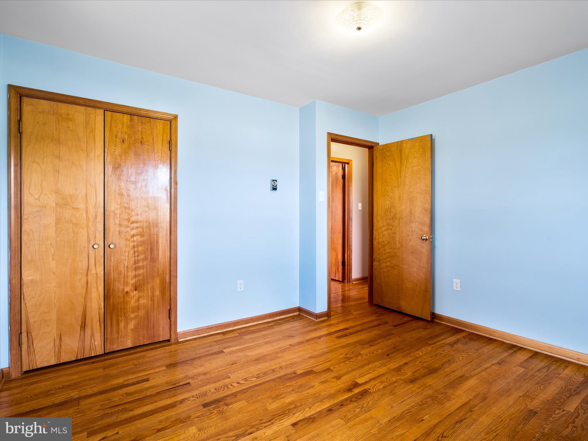 7429 Lewistown Road Thurmont, MD 21788 - Photo 31 of 68 a view of an empty room with wooden floor and a window