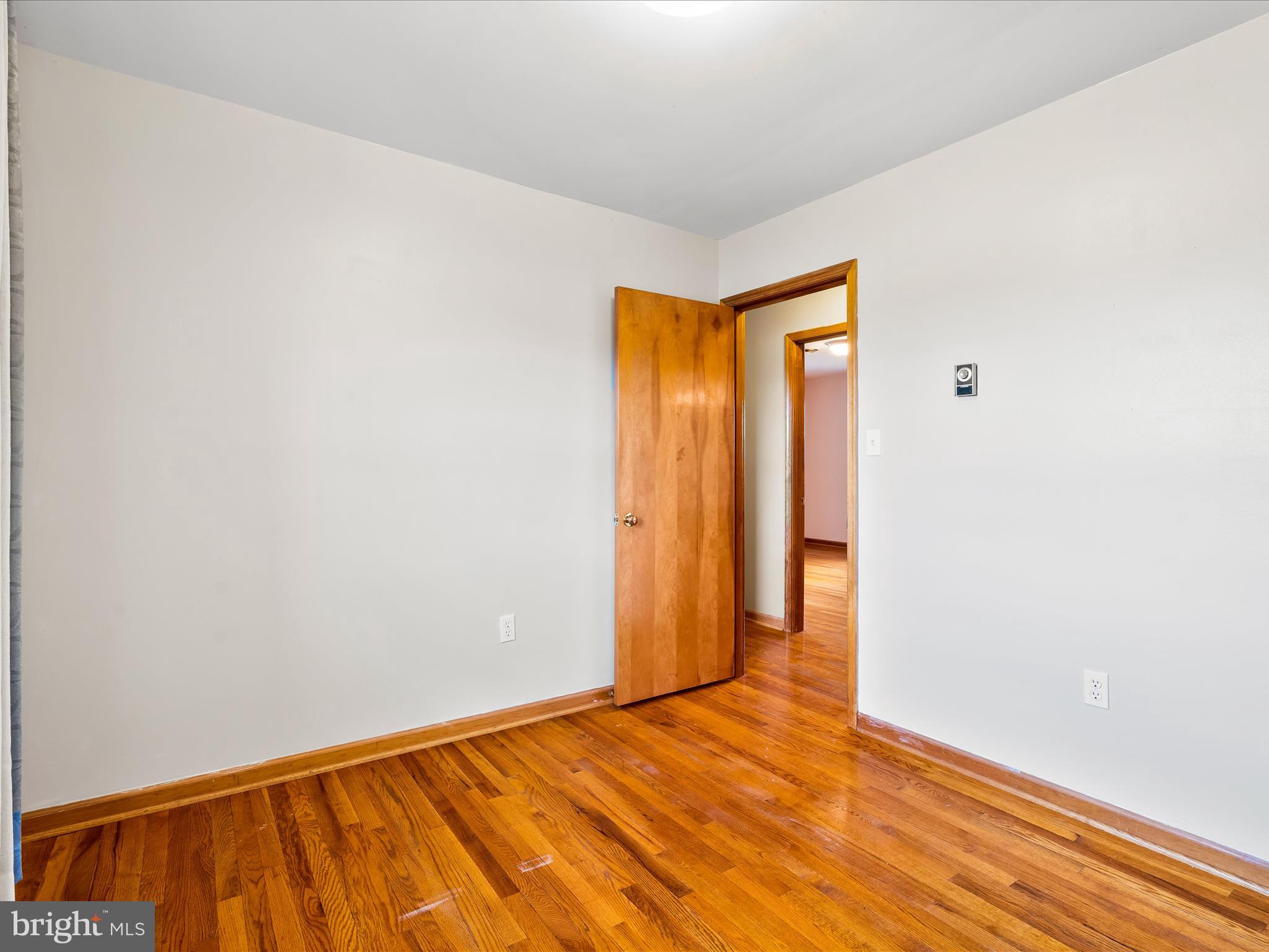 7429 Lewistown Road Thurmont, MD 21788 - Photo 34 of 68 a view of an empty room with wooden floor and a window