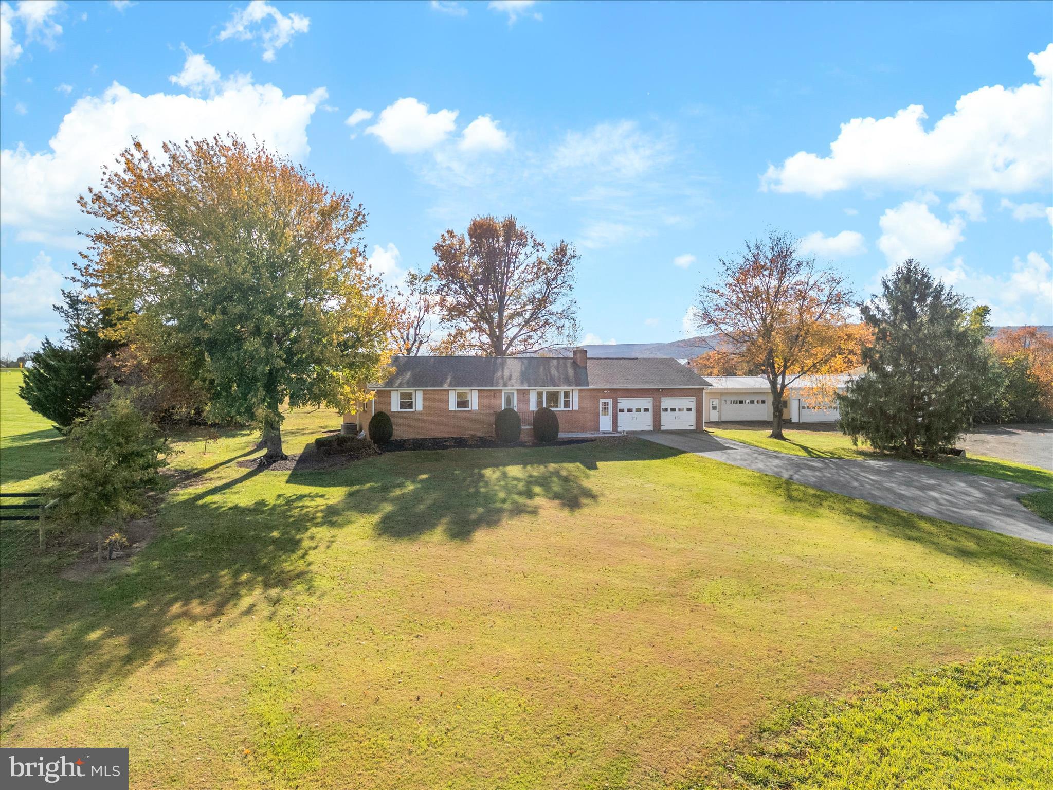 7429 Lewistown Road Thurmont, MD 21788 - Photo 52 of 68 a view of a swimming pool with a lawn chairs