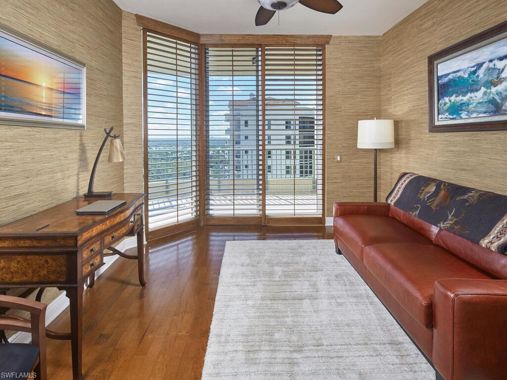23750 Via Trevi Way, Unit 2001 Estero, FL 34134 - Photo 20 of 26 Sitting room with wallpapered walls, ceiling fan, dark wood-type flooring, and an office area
