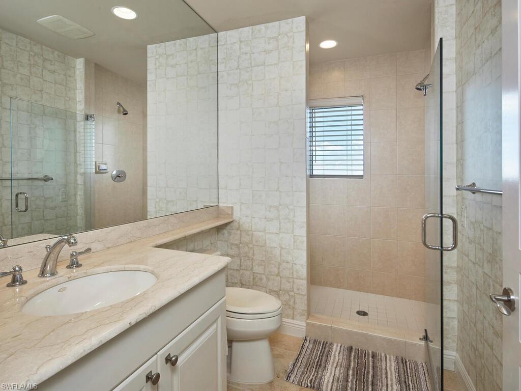 23750 Via Trevi Way, Unit 2001 Estero, FL 34134 - Photo 25 of 26 Full bath with vanity, a shower stall, recessed lighting, and light tile patterned flooring