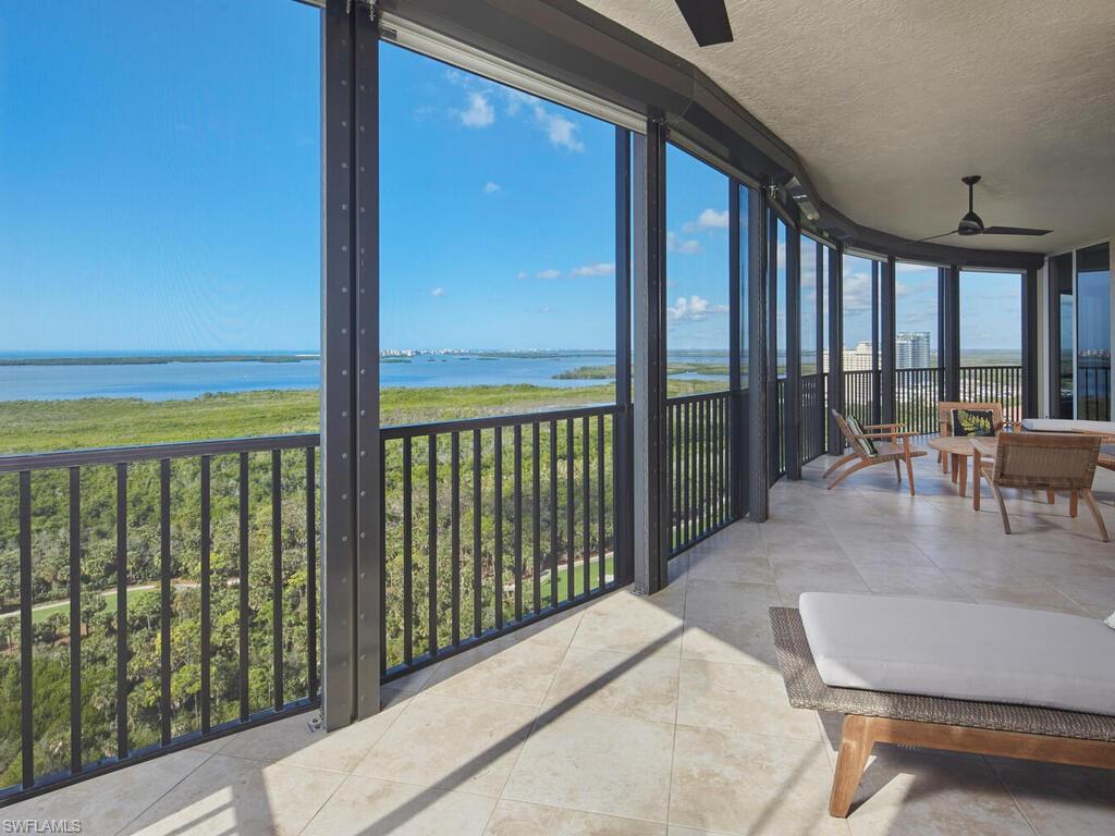 23750 Via Trevi Way, Unit 2001 Estero, FL 34134 - Photo 3 of 26 Sunroom featuring a wall of windows, a water view, a textured ceiling, and tile patterned floors