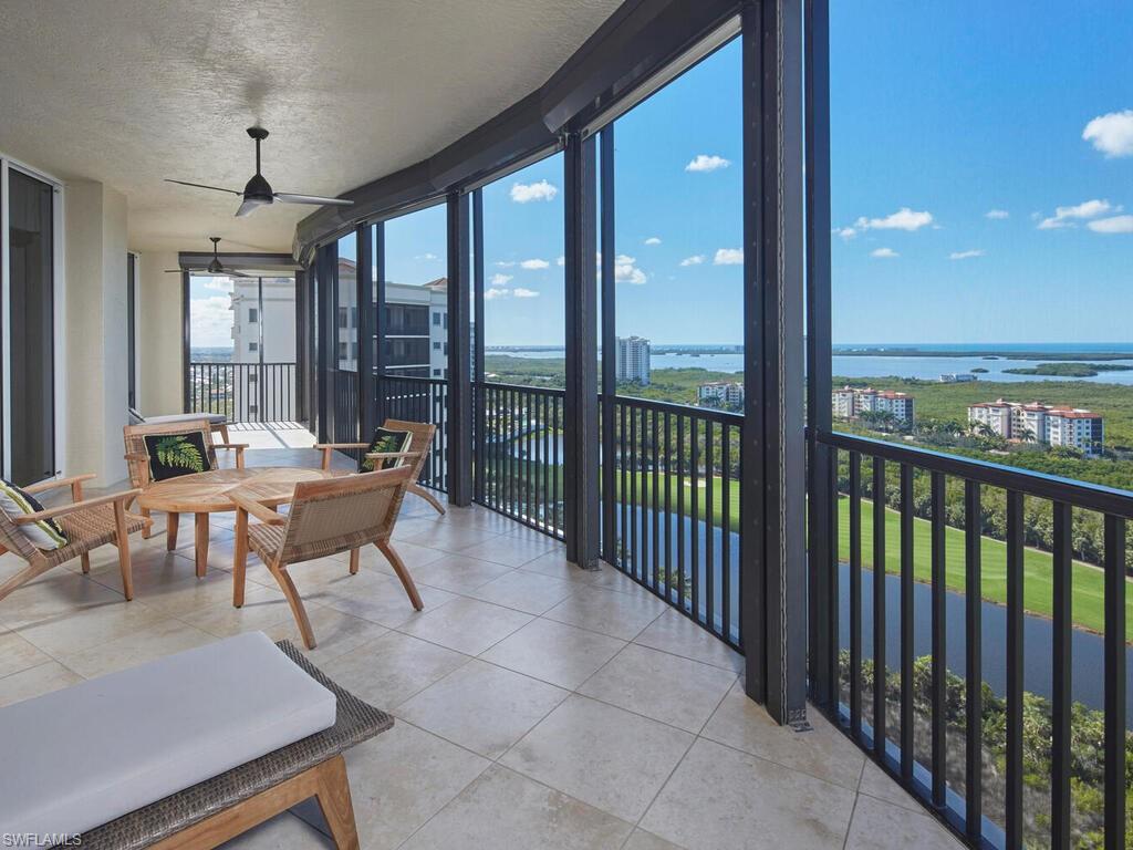 23750 Via Trevi Way, Unit 2001 Estero, FL 34134 - Photo 5 of 26 Sunroom with floor to ceiling windows, a water view, a textured ceiling, and tile patterned flooring