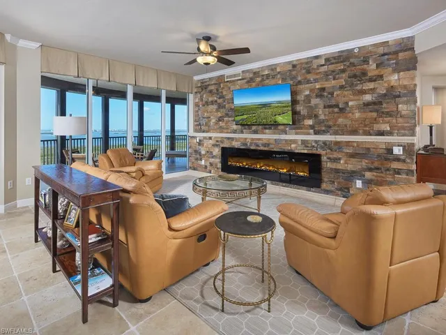 a living room with fireplace furniture and a flat screen tv