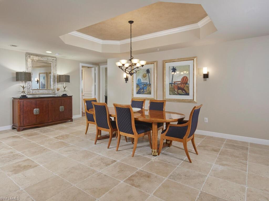 23750 Via Trevi Way, Unit 2001 Estero, FL 34134 - Photo 9 of 26 Dining space featuring ornamental molding, light tile patterned floors, and a chandelier