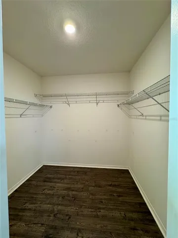 a bathroom with a granite countertop sink a mirror and shower