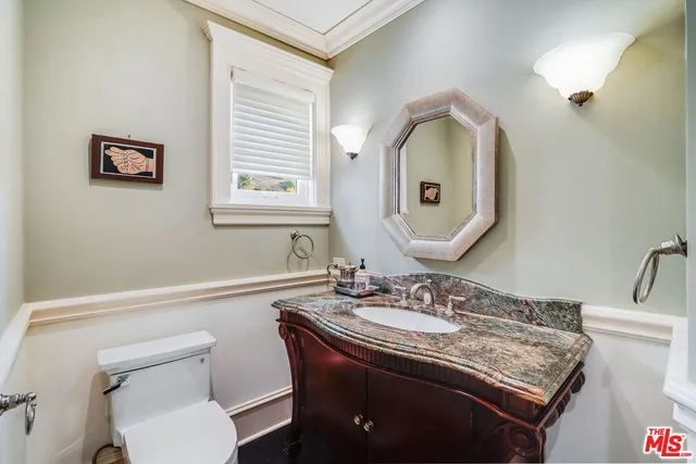 a bedroom with a bed and a large window with the outer view