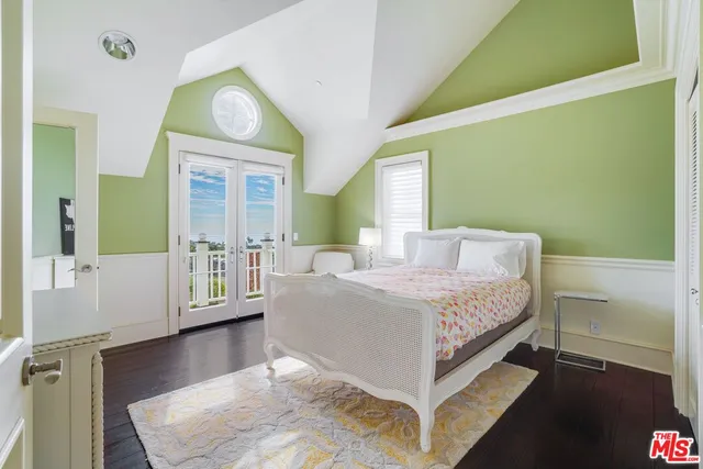 a room with pool table and windows