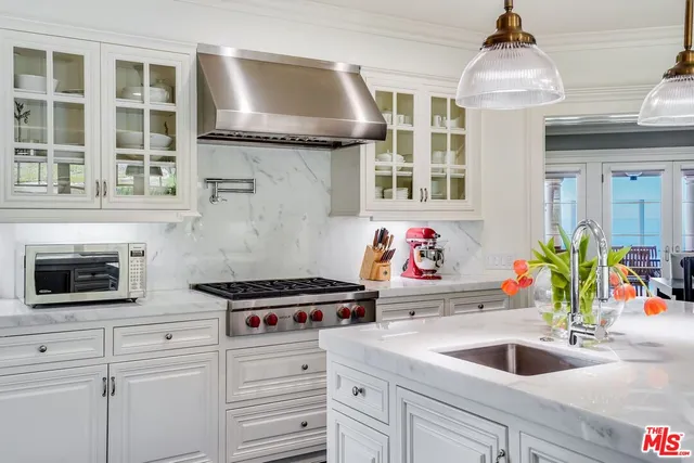 a kitchen with stainless steel appliances granite countertop a stove and wooden floor