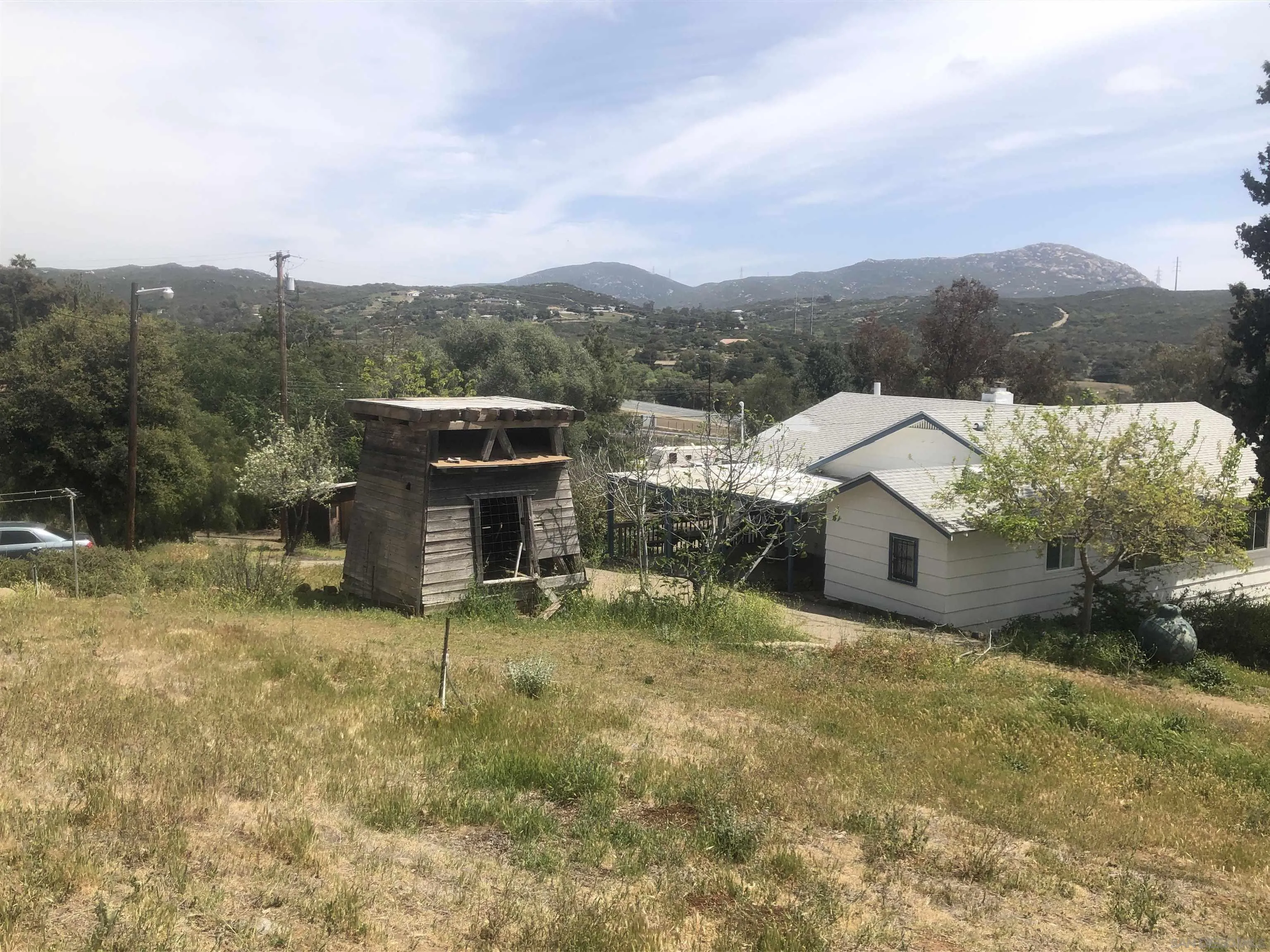 3962 Willows Road Alpine, CA 91901 - Photo 3 of 13 an aerial view of a house with a yard and mountain view