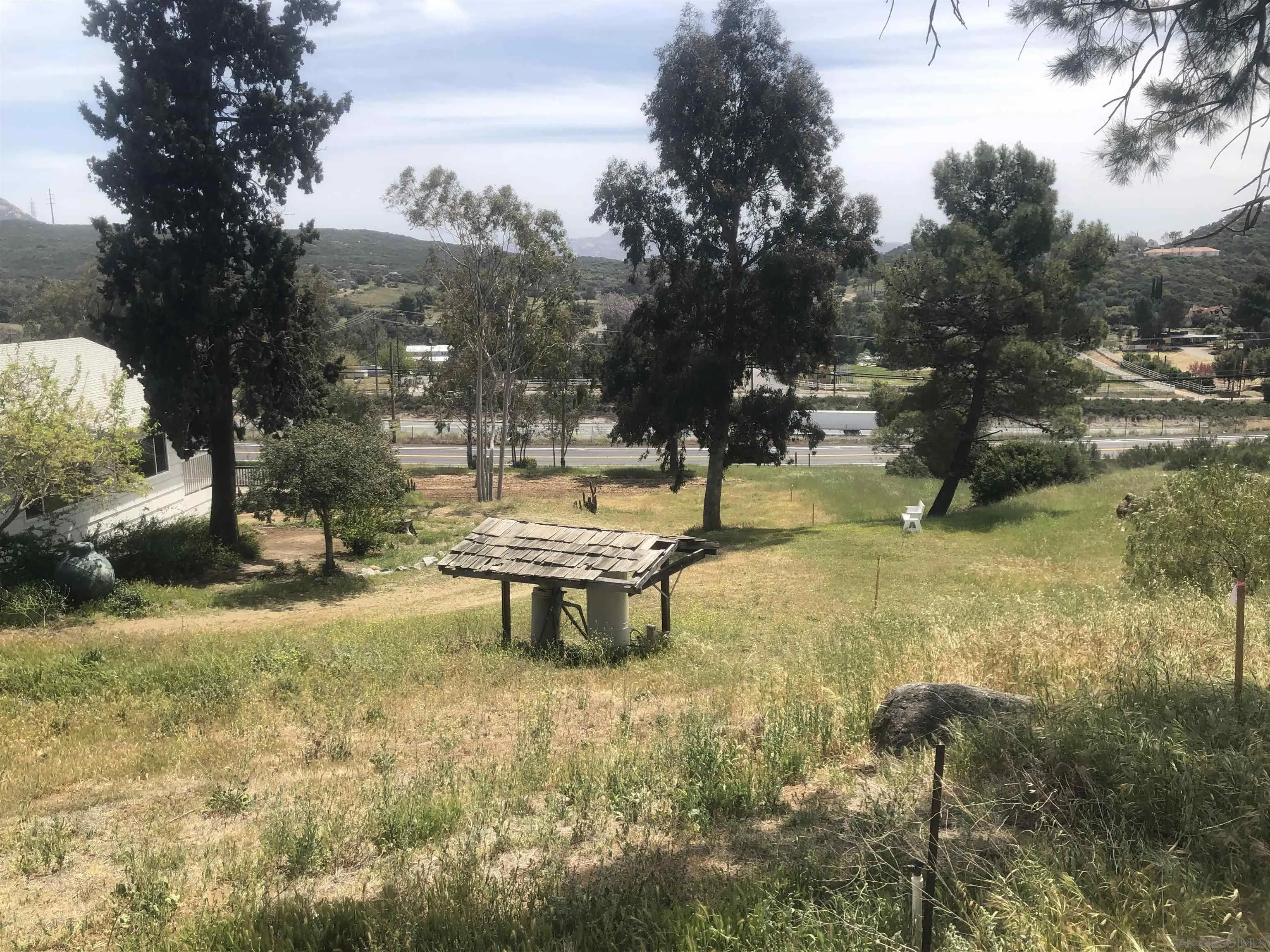 3962 Willows Road Alpine, CA 91901 - Photo 5 of 13 a view of a yard with plants and a bench