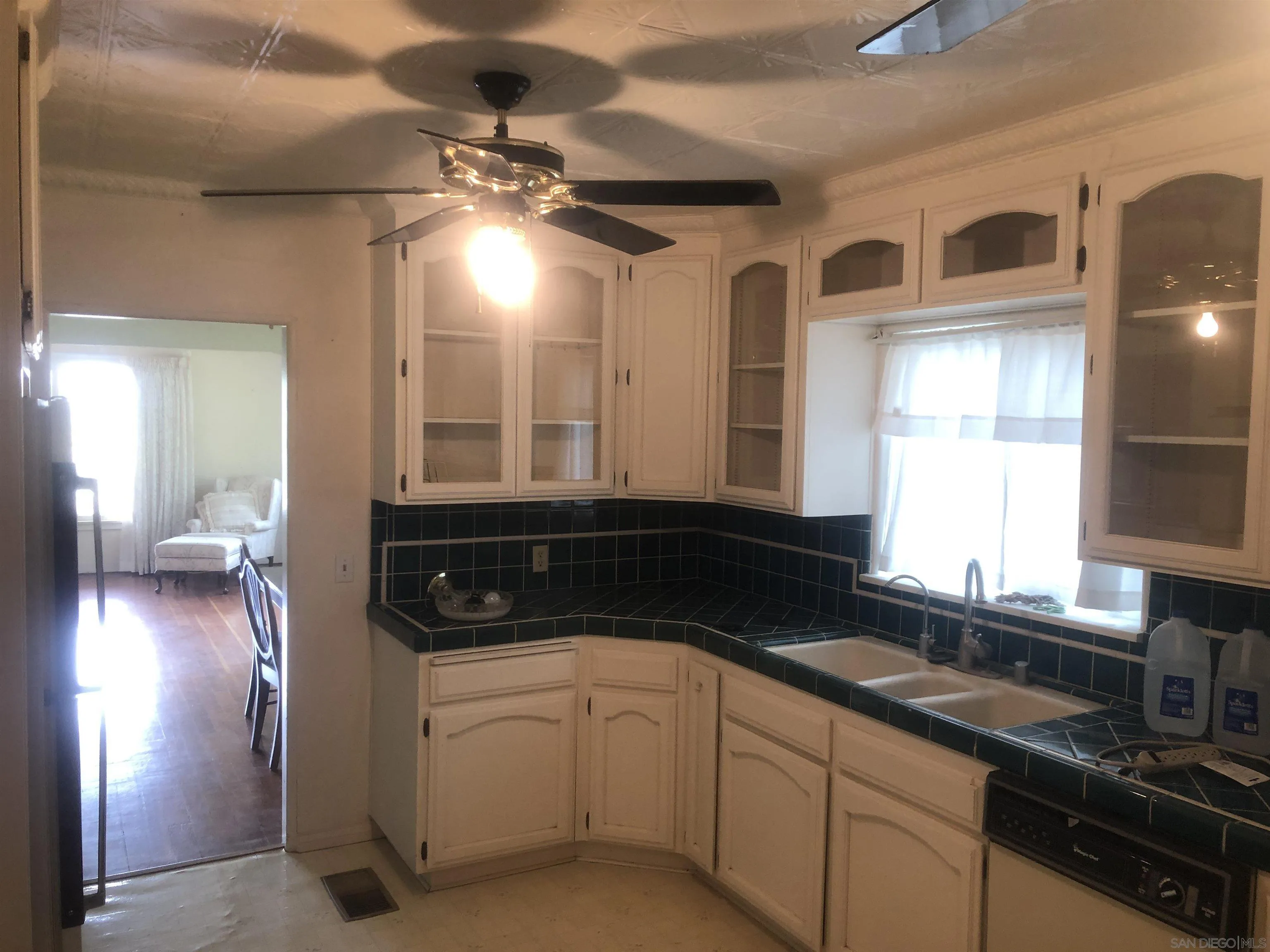 3962 Willows Road Alpine, CA 91901 - Photo 8 of 13 a kitchen with stainless steel appliances a sink stove and cabinets