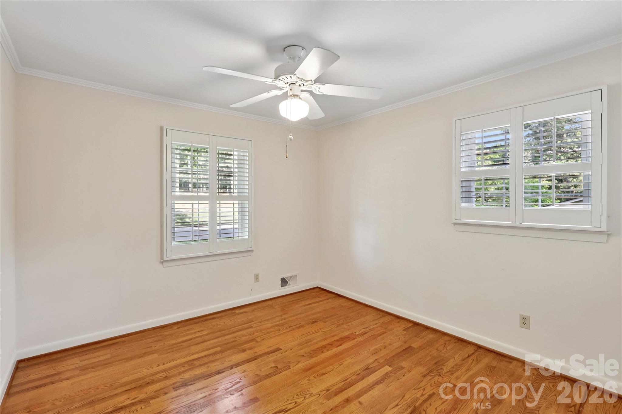 1002 Ridge Street Albemarle, NC 28001 - Photo 27 of 45 a view of an empty room with wooden floor and a window