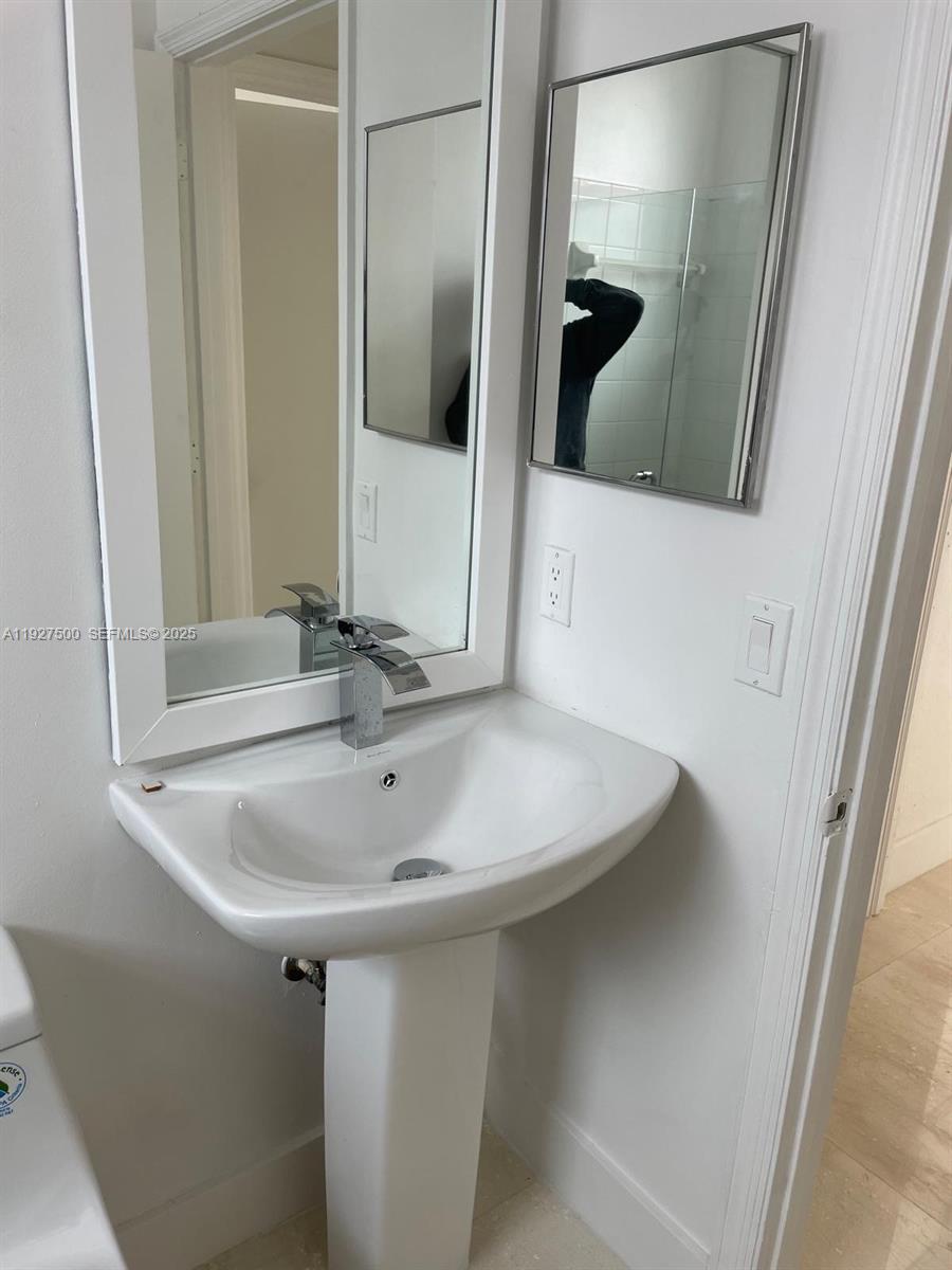 15964 Southwest 139th Street Miami, FL 33196 - Photo 15 of 22 a bathroom with a sink and mirror