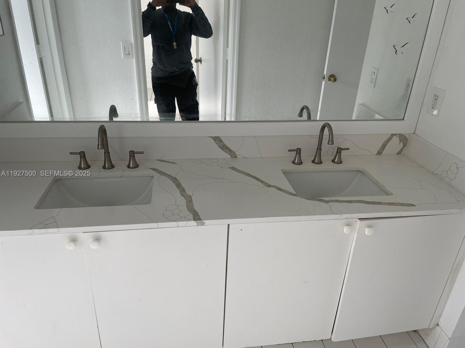 15964 Southwest 139th Street Miami, FL 33196 - Photo 18 of 22 a bathroom with a sink and a mirror