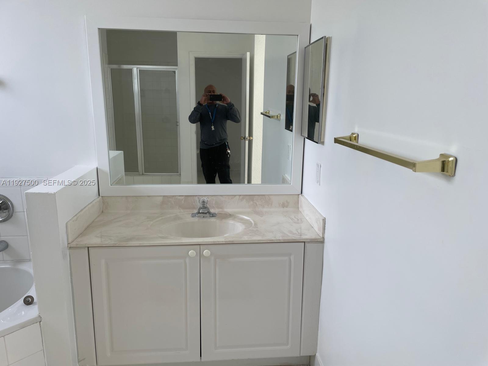 15964 Southwest 139th Street Miami, FL 33196 - Photo 20 of 22 a bathroom with a granite countertop sink and a mirror