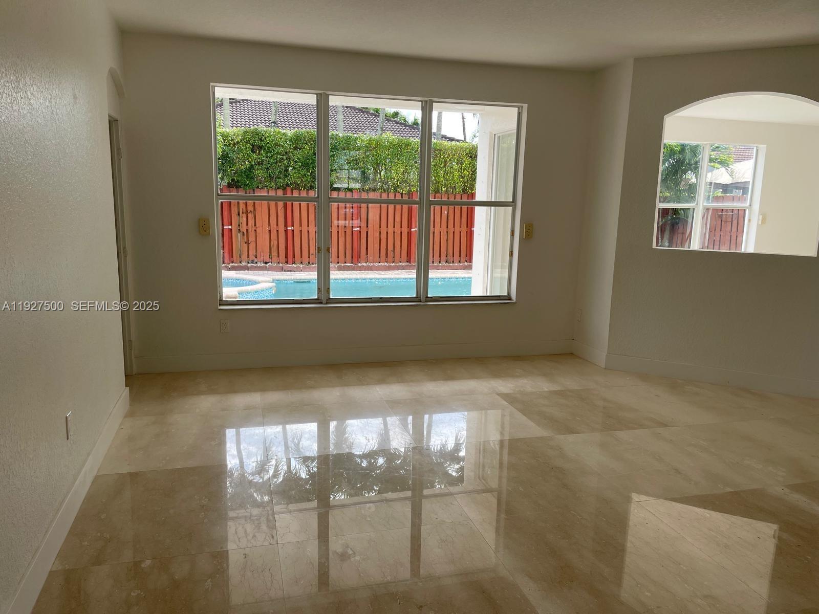 15964 Southwest 139th Street Miami, FL 33196 - Photo 3 of 22 a view of an empty room and window