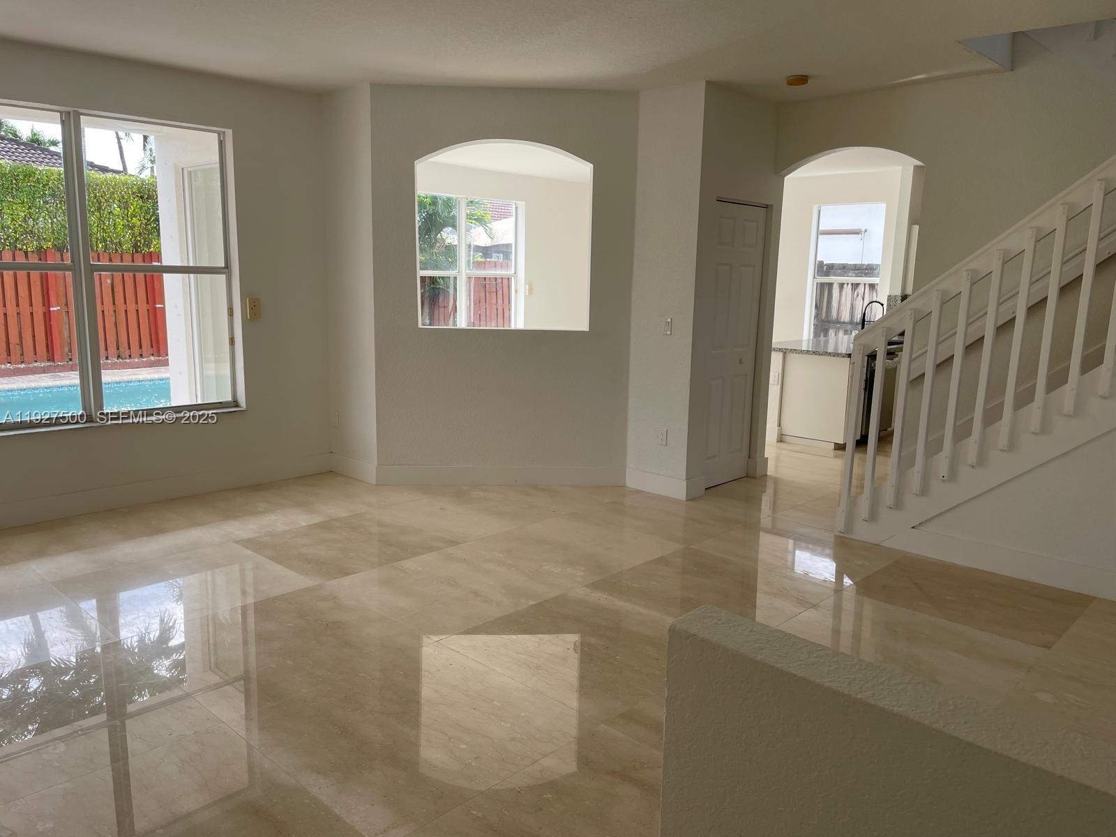 15964 Southwest 139th Street Miami, FL 33196 - Photo 4 of 22 an empty room with windows