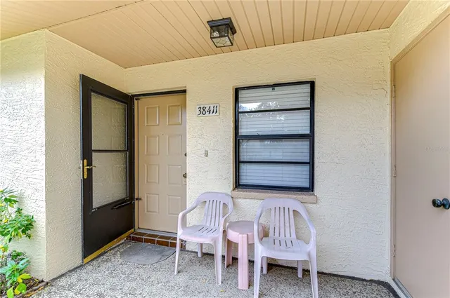 a bedroom with a chair and a window