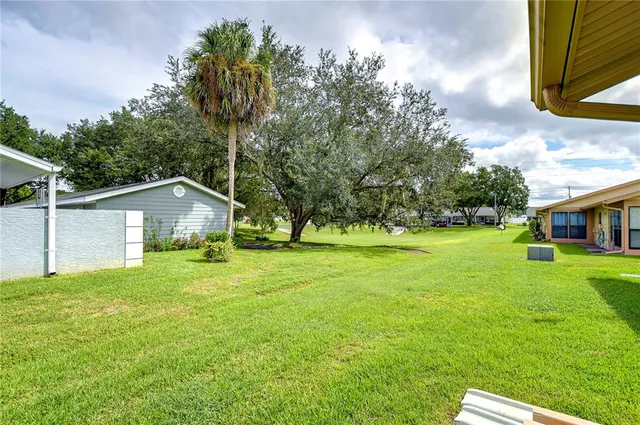 a front view of house with yard and trees