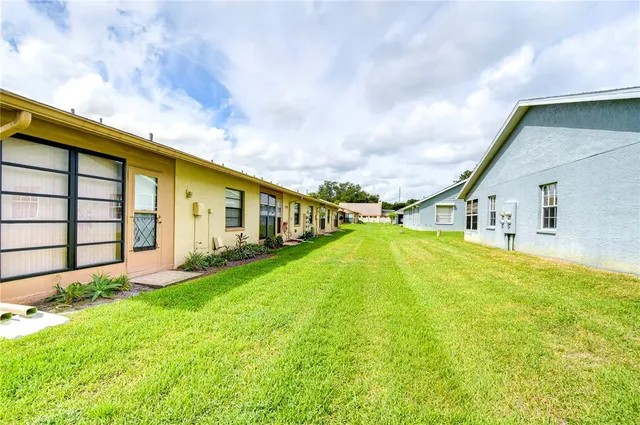 a house view with swimming pool in front of it