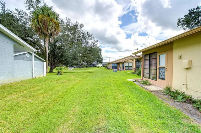 a view of a house with backyard and garden