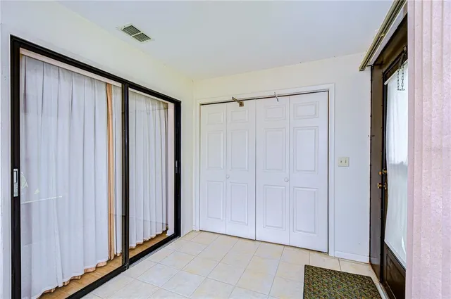 a view of a kitchen with white cabinets