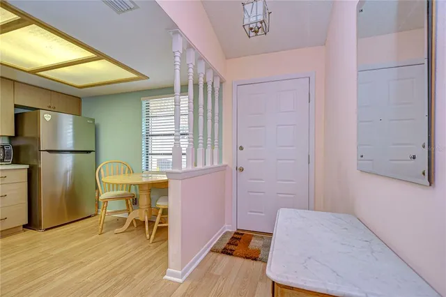 a kitchen with cabinets and chairs