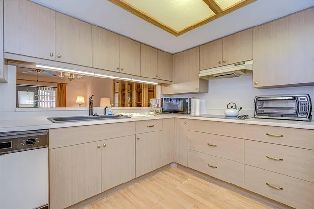 a kitchen with cabinets a sink and appliances