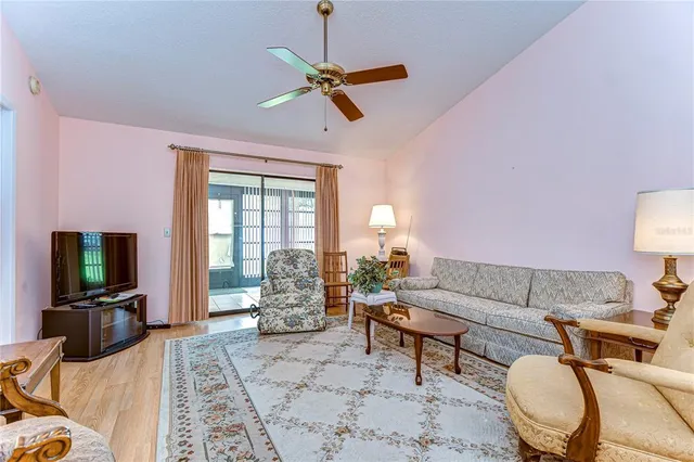 a living room with furniture a dining table and a piano
