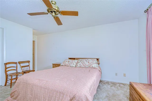 a bedroom with a large bed and dresser