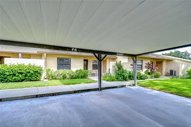 a view of a house with a big yard and potted plants