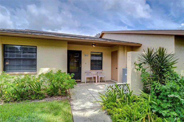 a front view of house with a garden