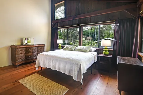 a bedroom with a bed window and a table