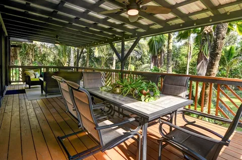 a view of a balcony with chairs and wooden floor