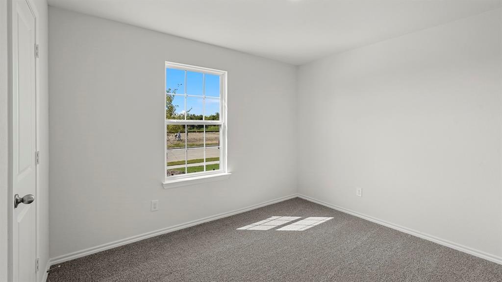 628 Dunham Road Farmersville, TX 75442 - Photo 4 of 36 Neutral wall paint, carpet flooring, and a single window with white trim