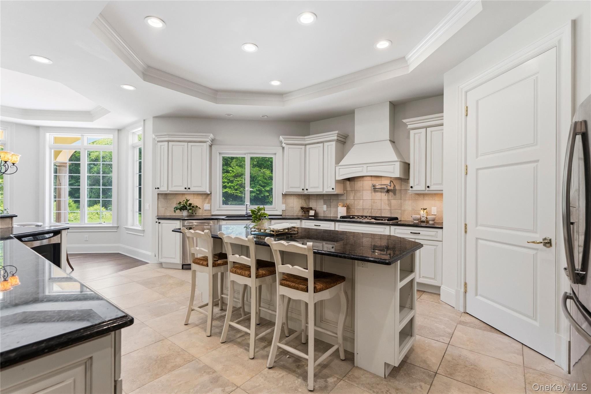 1960 Midlane Road South Syosset, NY 11791 - Photo 16 of 46 a kitchen with stainless steel appliances granite countertop table chairs sink and cabinets