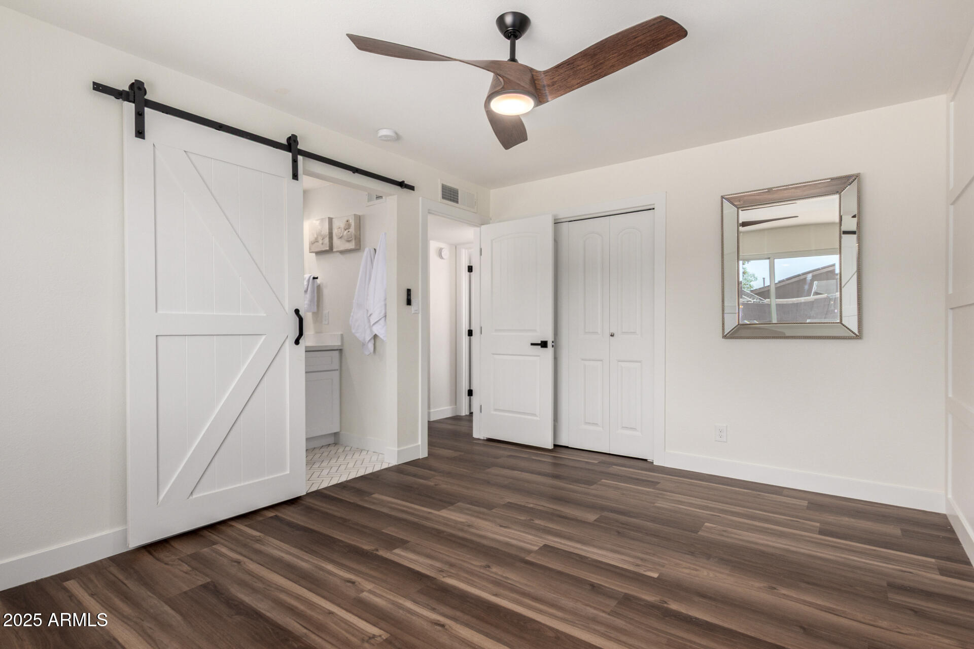 1539 West 5th Street Tempe, AZ 85281 - Photo 9 of 12 a view of an empty room with wooden floor and a ceiling fan