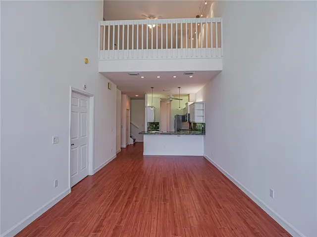 a view of a kitchen with wooden floor and a sink