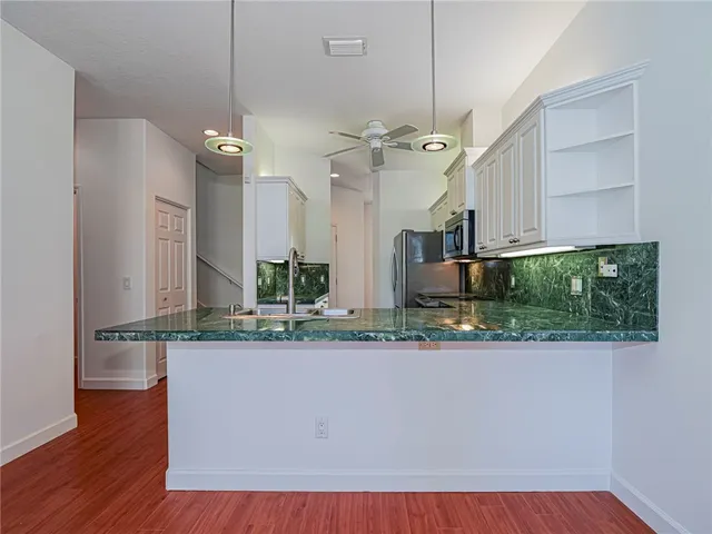 a view of a kitchen with a sink and living room