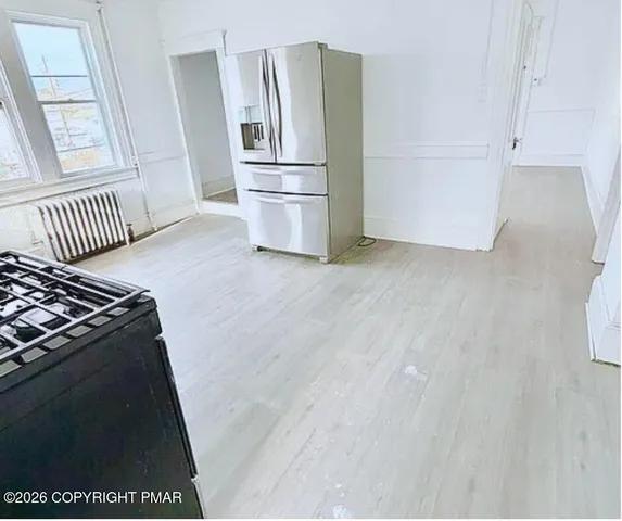 a kitchen with a refrigerator stove and cabinets