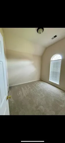 a black and white photo of a cabinet with wooden floor