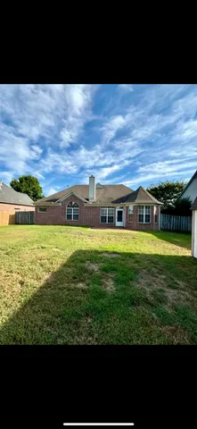 a view of a yard next to a building