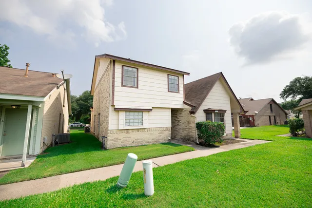 a front view of house with yard and green space