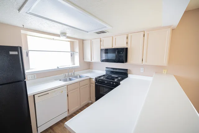 a kitchen with a sink stove and microwave