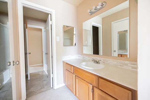 a bathroom with a sink and a mirror