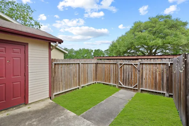 a view of a backyard with wooden fence