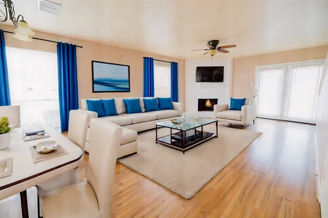 a living room with furniture and wooden floor