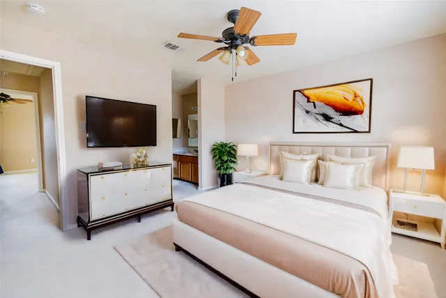 a bedroom with a bed and a flat screen tv